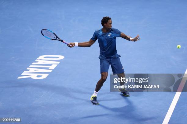 France's Gael Monfils returns the ball to Italy's Paolo Lorenzi during the first round of the ATP Qatar Open tennis competition in Doha on January 2,...