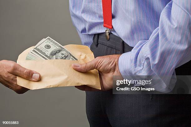 dollar bribe to businessman - bribing stockfoto's en -beelden