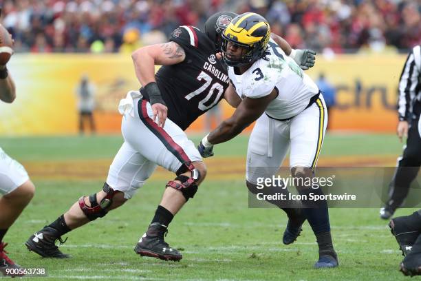 Michigan Wolverines defensive lineman Rashan Gary is blocked by South Carolina Gamecocks offensive lineman Alan Knott during the 2018 Outback Bowl...