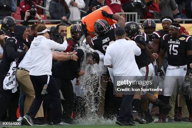 South Carolina Gamecocks defensive lineman Ulric Jones and South Carolina Gamecocks defensive lineman Keir Thomas dump a bucket of water on South...