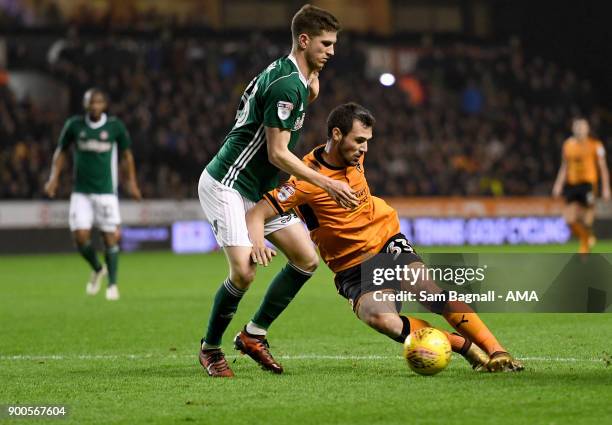 Chris Mepham of Brentford and Leo Bonatini of Wolverhampton Wanderers during the Sky Bet Championship match between Wolverhampton and Brentford at...