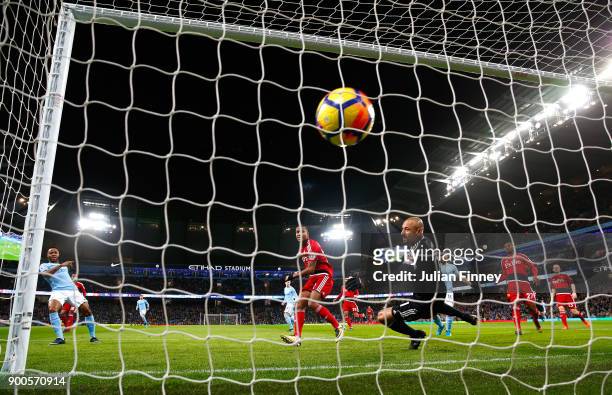 Raheem Sterling of Manchester City scores his sides first goal past Heurelho Gomes of Watford during the Premier League match between Manchester City...