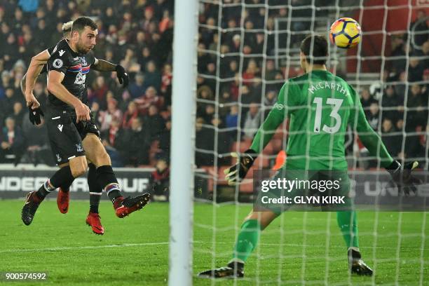 Crystal Palace's Scottish midfielder James McArthur shoots to score their first goal past Southampton's English goalkeeper Alex McCarthy during the...