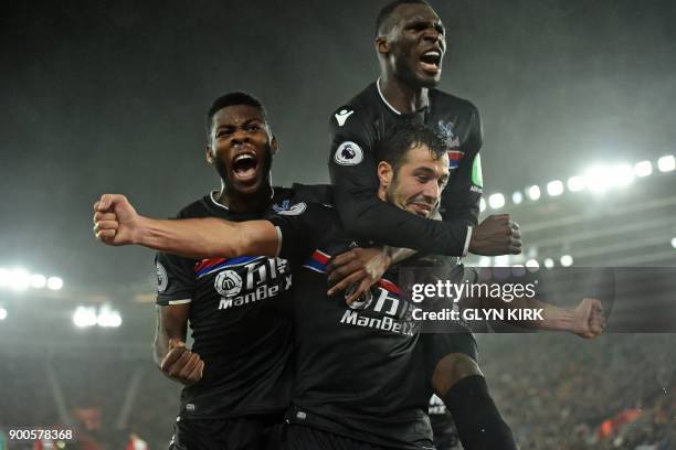 Crystal Palace's Serbian midfielder Luka Milivojevic celebrates with Crystal Palace's Dutch defender Timothy Fosu-Mensah and Crystal Palace's...