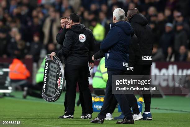 Billy McKinlay, West Ham United assistant manager shouts at Alan Pardew, Manager of West Bromwich Albion during the Premier League match between West...