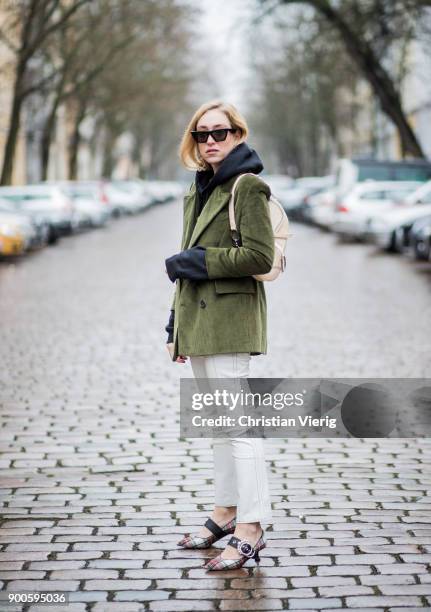 Sonia Lyson wearing Miu Miu shoes, Dior saddle bag, green oversized cord blazer Mango, Mango pants, hoodie Koenig Souvenir, Celine sunglasses on...