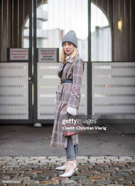 Sonia Lyson wearing checked trench wool coat Uterque, white Mango shoes, Fendi bag, Citizen of Humanity jeans, Gucci belt, Acne beanie on January 2,...