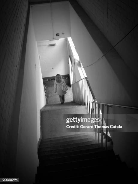 girl with a handbag go down stairs - southern european descent fotografías e imágenes de stock