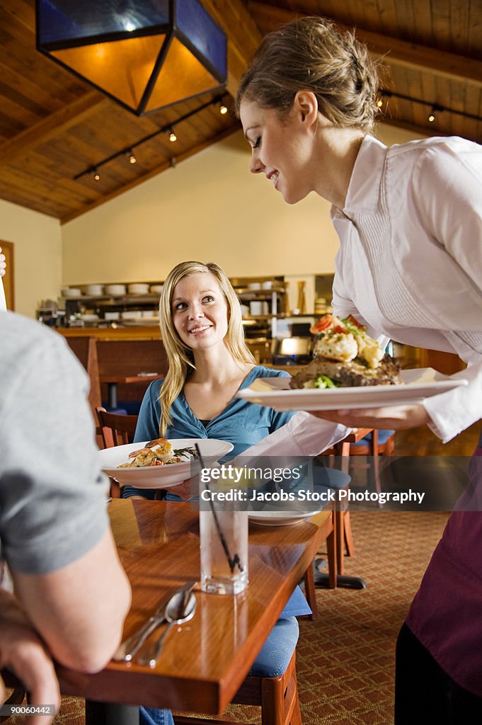 Waitress Serving Food in Restaurant