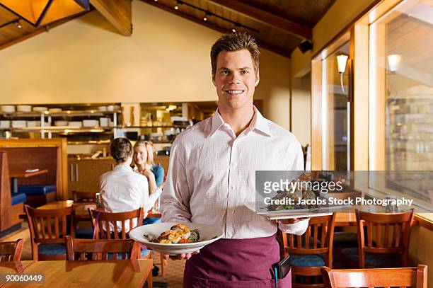 portrait of smiling waiter in restaurant - moving down to seated position stock pictures, royalty-free photos & images