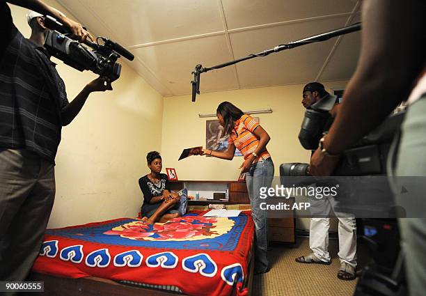 Ivorian comedians act during a scene for an episode of a TV serie "Ma famille" directed by Ivorian director's Akissi Delta in Abidjan on August 21,...