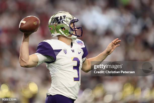 Quarterback Jake Browning of the Washington Huskies throws a warm up pass before the start of the second half of the Playstation Fiesta Bowl against...