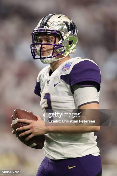 Quarterback Jake Browning of the Washington Huskies warms up before the start of the second half of the Playstation Fiesta Bowl against the Penn...