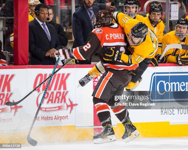 Chris Pohlkamp of the Bowling Green Falcons body checks Justin Misiak of the Michigan Tech Huskies during the championship game of the Great Lakes...
