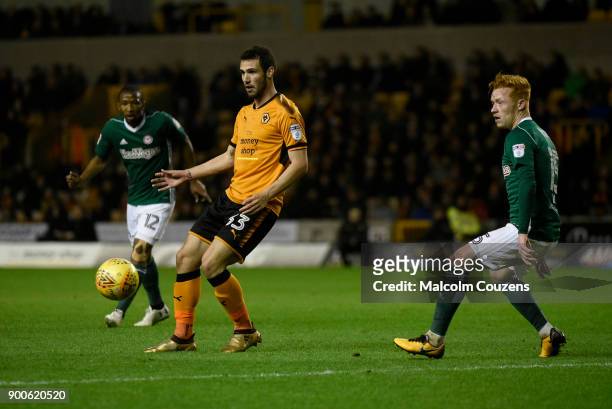 Leonardo Bonatini of Wolverhampton Wanderers holds up the ball ahead of Ryan Woods of Brentford during the Sky Bet Championship match between...
