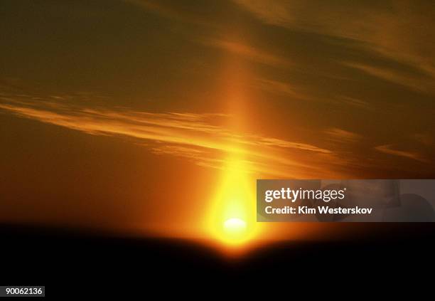 sun pillar over low sun: august  mcmurdo sound,  antarcticta - westerskov stock pictures, royalty-free photos & images