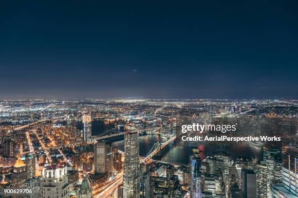 aerial view of manhattan skyline at night - new york city skyline night stock pictures, royalty-free photos & images