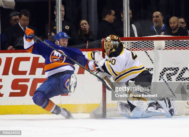 Jason Chimera of the New York Islanders gets tangled up with Tuukka Rask of the Boston Bruins during the first period at the Barclays Center on...