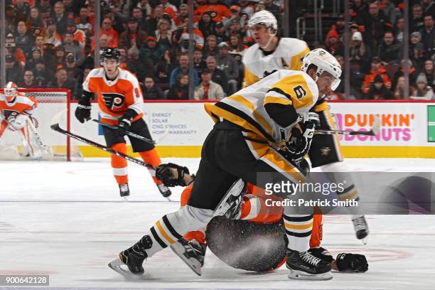Jamie Oleksiak of the Pittsburgh Penguins checks Jakub Voracek of the Philadelphia Flyers during the second period at Wells Fargo Center on January...