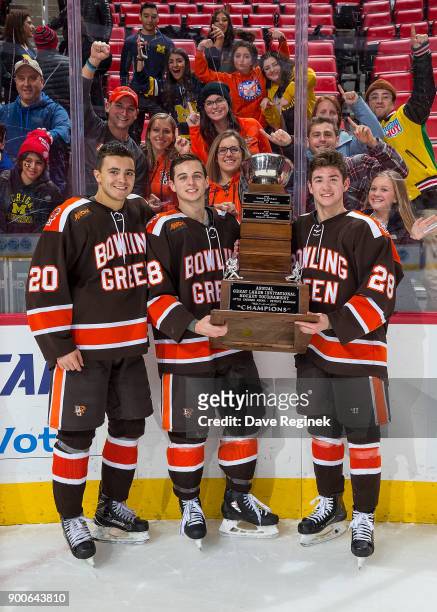 Connor Ford, Brett D'Andrea and Brandon Kruse of the Bowling Green Falcons pose for a picture with the John MacInnes Cup after the championship game...