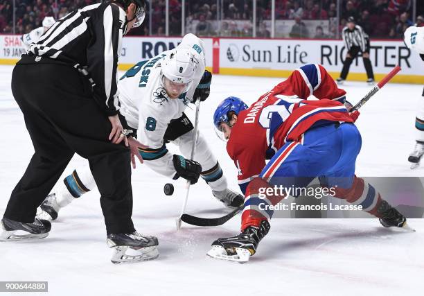 Phillip Danault of the Montreal Canadiens and Joe Pavelski of the San Jose Sharks face off in the NHL game at the Bell Centre on January 2, 2018 in...