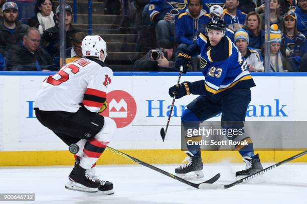 Dmitrij Jaskin of the St. Louis Blues takes a shot as Steven Santini of the New Jersey Devils defends at Scottrade Center on January 2, 2018 in St....