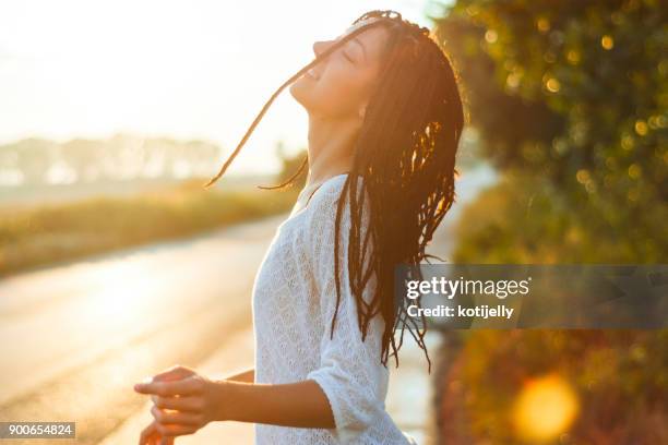 lovely young woman enjoying the sunset - aura stock pictures, royalty-free photos & images