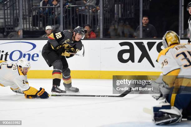 Goalie Pekka Rinne makes a save while his Nashville Predators teammate Anthony Bitetto defends Tomas Nosek of the Vegas Golden Knights during the...