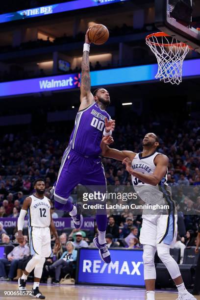 Willie Cauley-Stein of the Sacramento Kings dunks over Brandan Wright of the Memphis Grizzlies at Golden 1 Center on December 31, 2017 in Sacramento,...
