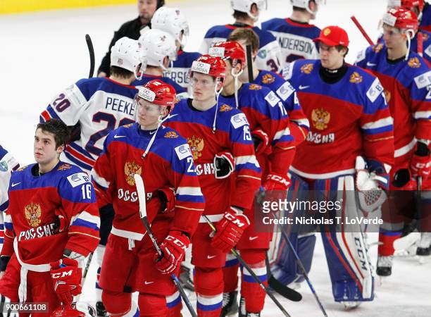 Members of team Russia and the United States shake hands following team USA's 4-2 win in the Quarterfinal IIHF World Junior Championship game at the...