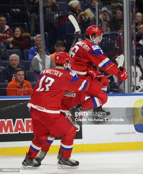 Andrei Altybarmakyan of Russia celebrates his game tying goal with Mikhail Maltsev during the third period of play in the Quarterfinal IIHF World...