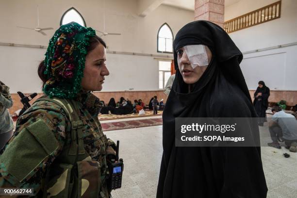 Ala Hama who was just rescued from Raqqa is talking to a YPJ soldat. She lost one of her eyes, while she was in the balcony of her house and an...