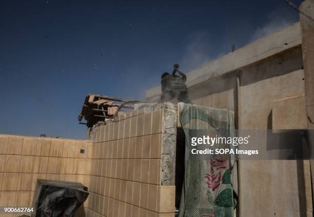 Syrian Democratic Force fighter firing a RPG toward the National Hospital, a key position which was held by Islamic State jihadists along the Western...