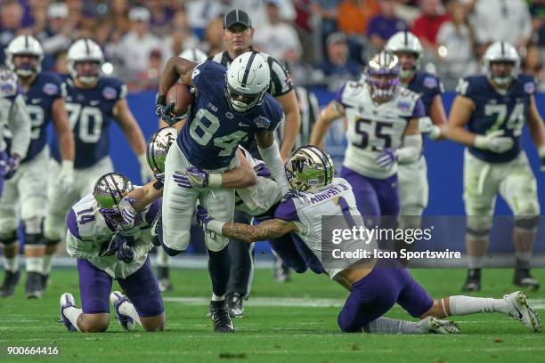 Juwan Johnson of the Penn State Nittany Lions gets tackled by JoJo McIntosh of the Washington Huskies and Byron Murphy of the Washington Huskies in...