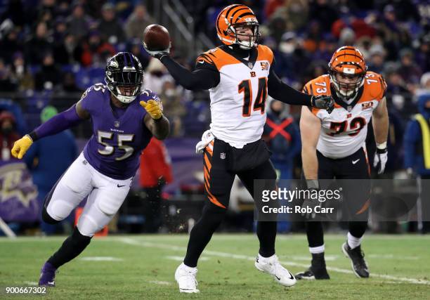 Quarterback Andy Dalton of the Cincinnati Bengals gets off a pass in front of outside linebacker Terrell Suggs of the Baltimore Ravens at M&T Bank...