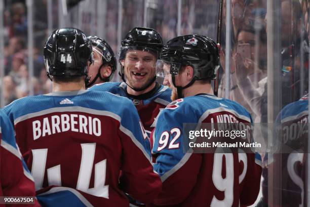 Erik Johnson of the Colorado Avalanche celebrates a win against the Winnipeg Jets with teammates Mark Barberio and Gabriel Landeskog at the Pepsi...