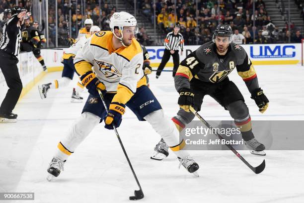 Anthony Bitetto of the Nashville Predators handles the puck with Pierre-Edouard Bellemare of the Vegas Golden Knights defending during the game at...