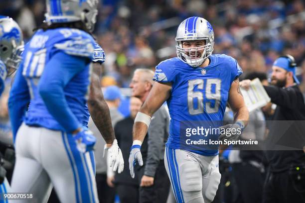 Detroit Lions defensive end Anthony Zettel greets his teammates coming off the field following a third down stop during a NFL football game between...