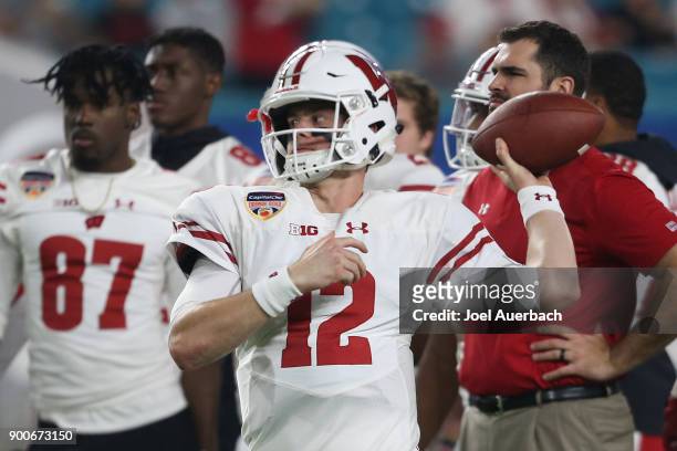 Alex Hornibrook of the Wisconsin Badgers throws the ball prior to the Capital One Orange Bowl game against the Miami Hurricanes at Hard Rock Stadium...