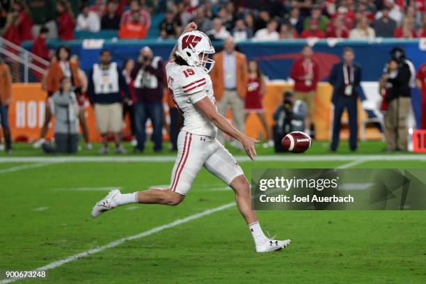 Anthony Lotti of the Wisconsin Badgers punts the ball against the Miami Hurricanes during the 2017 Capital One Orange Bowl at Hard Rock Stadium on...