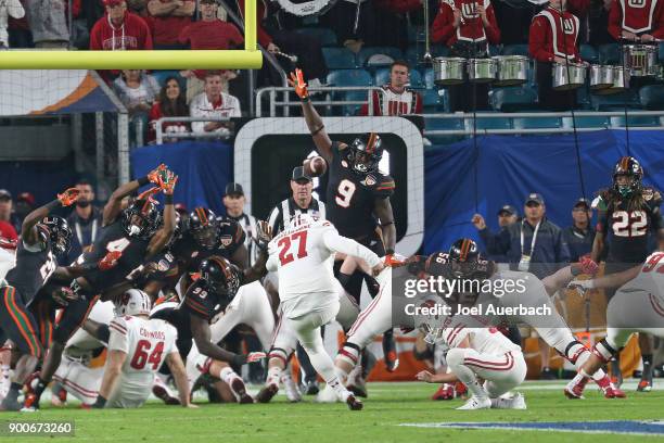 Chad Thomas of the Miami Hurricanes is unable to block the point after touchdown kick by Rafael Gaglianone of the Wisconsin Badgers during the 2017...