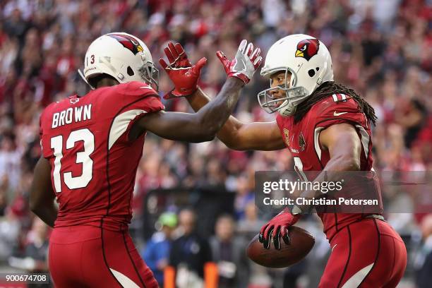 Wide receiver Larry Fitzgerald of the Arizona Cardinals celebrates with Jaron Brown after Fitzgerald scored on a 13 yard touchdown reception during...