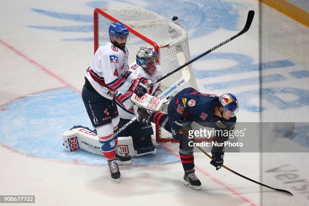 Mark Stuart of Adler Mannheim vies Mads Christensen of Red Bull Munich during the 38th game day of the German Ice Hockey League between Red Bull...