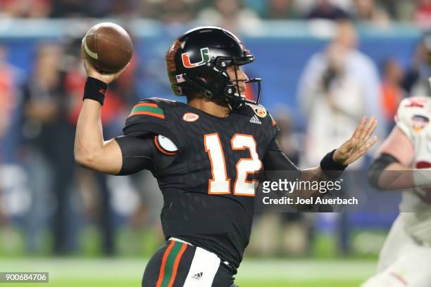 Malik Rosier of the Miami Hurricanes throws the ball against the Wisconsin Badgers during the 2017 Capital One Orange Bowl at Hard Rock Stadium on...