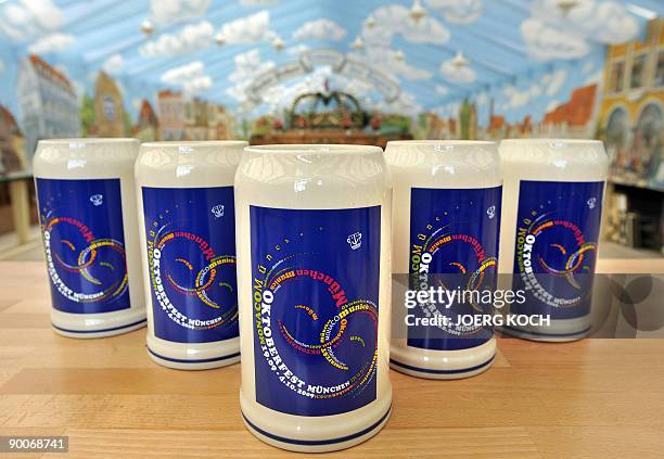 This year's Oktoberfest beer mugs stand on a table in a party tent in Munich, southern Germany on August 25, 2009. The world famous beer festival...