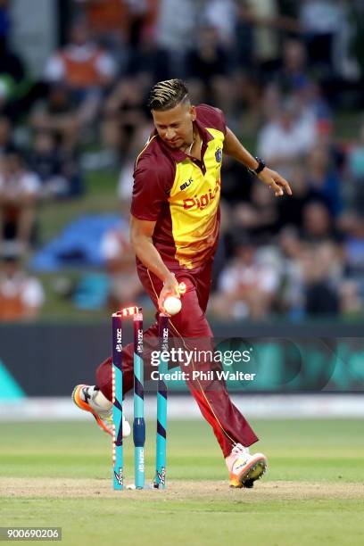 Rayad Emrit of the West Indies runs out Anaru Kitchen of the New Zealand Black Caps during game three of the Twenty20 series between New Zealand and...