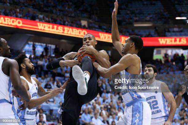 Tulane's Cam Reynolds grabs a rebound from North Carolina's Garrison Brooks during the North Carolina Tar Heels game versus the Tulane Green Wave on...