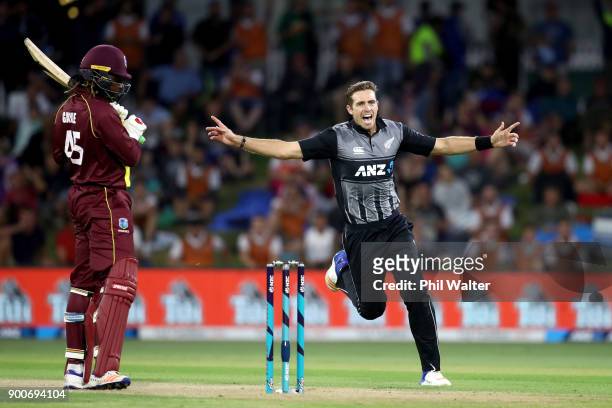 Tim Southee of the New Zealand Black Caps bats celebrates his wicket of Chris Gayle of the West Indies during game three of the Twenty20 series...