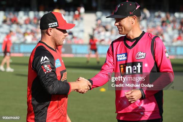 Aaron Finch of the Renegades and Johan Botha of the Sixers shake hands after the coin toss during the Big Bash League match between the Melbourne...