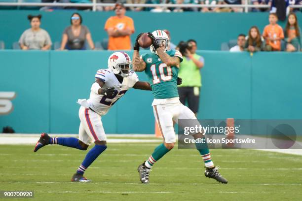 Miami Dolphins wide receiver Kenny Stills catches a pass against Buffalo defensive back Tre'Davious White during an NFL football game between the...